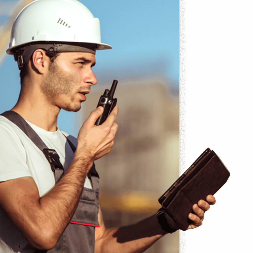  A construction worker speaks into a walkie-talkie while using an iPad as workforce mobility tool