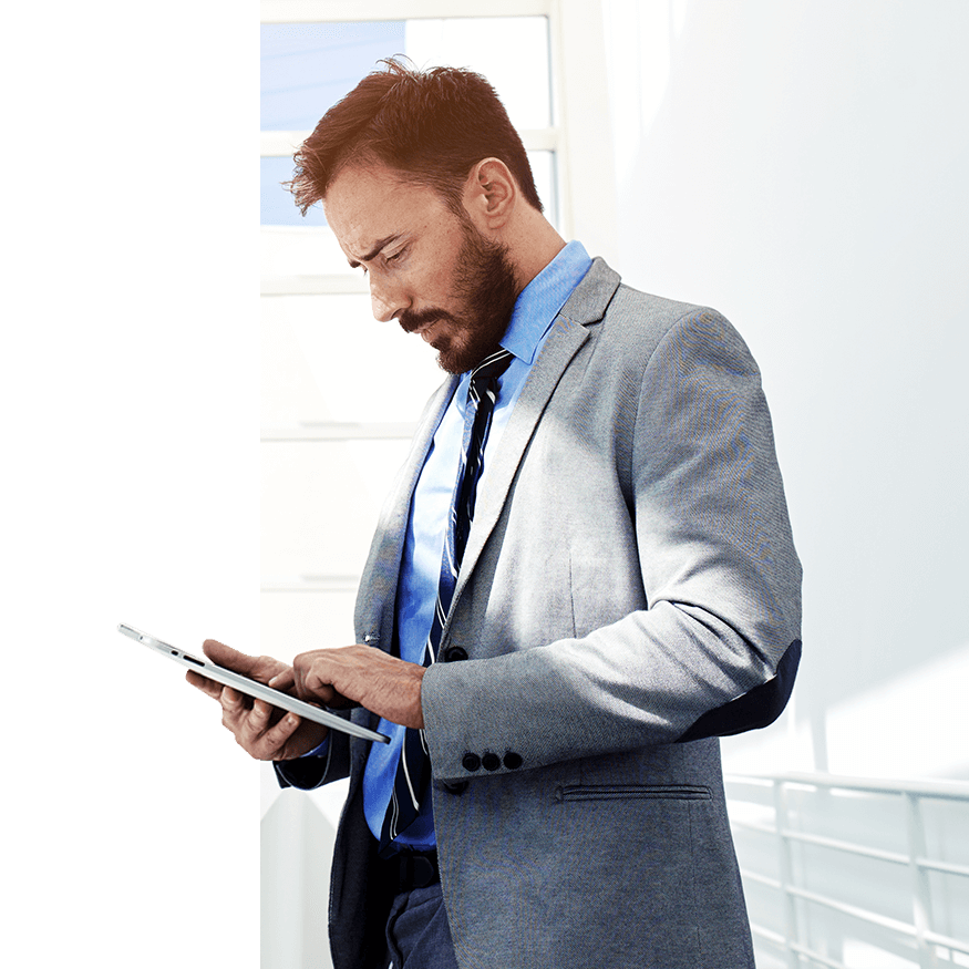 A man stands while making use of a tablet device running Mobile 1’s Enterprise Mobility solution